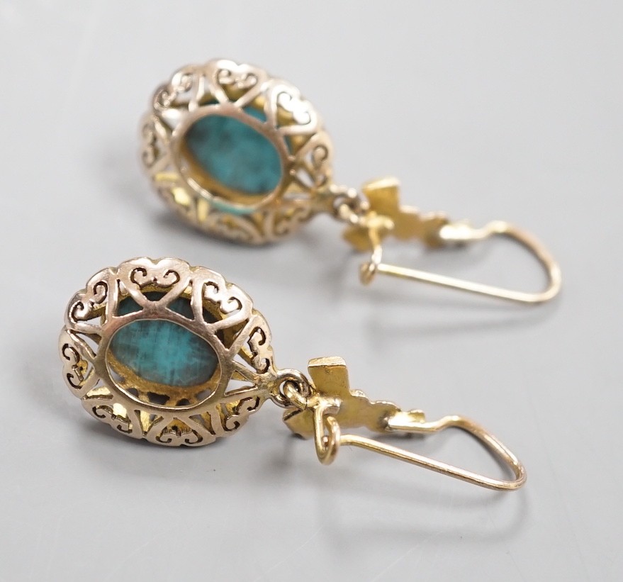 A pair of early 20th century pierced yellow metal and turquoise set drop earrings, 35mm, gross weight 4.3 grams.